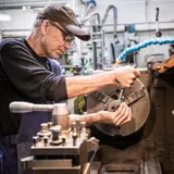 A man working on a lathe machine 