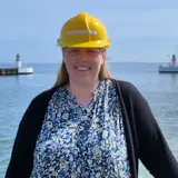 Woman in dress and black shirt in front of lighthouses