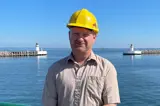 Man in beige shirt and yellow helmet