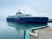 Blue and red ferry leaving port