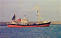 Red fishing vessel at sea